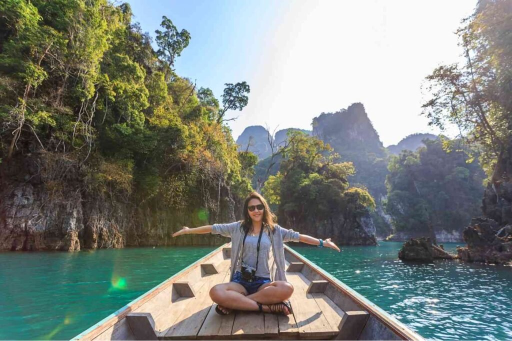 A woman relaxes on a boat, enjoying the tranquil atmosphere of a lake a positive travel can delay aging